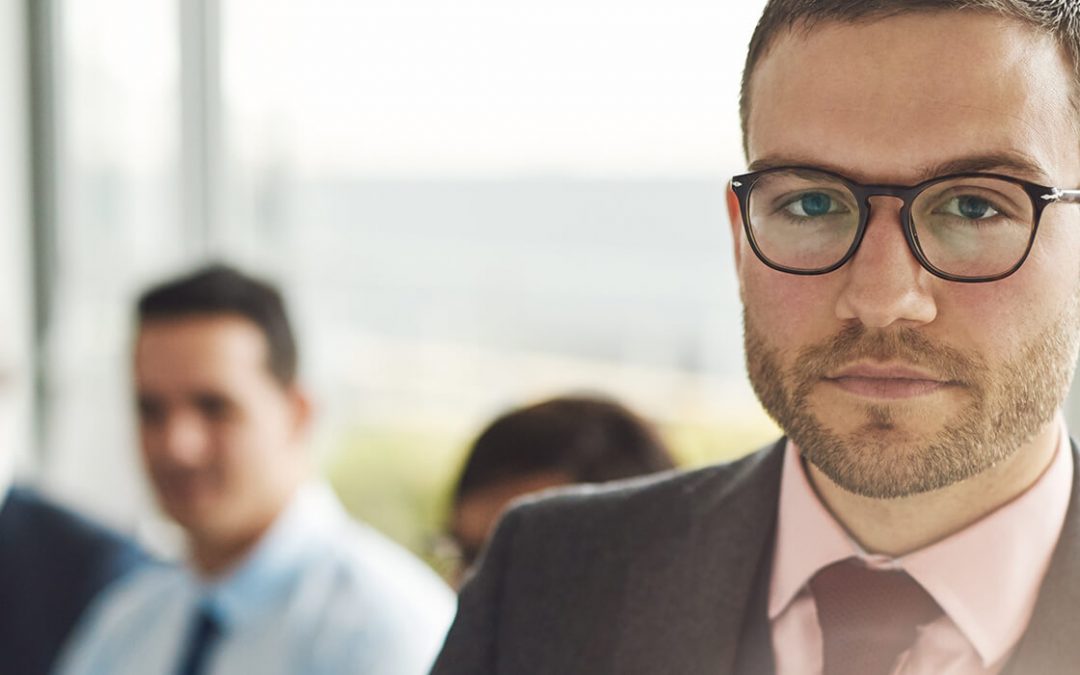 business man with glasses staring at viewer
