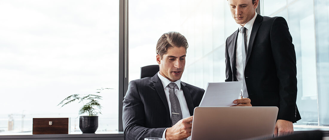 Two lawyers looking over papers in law office